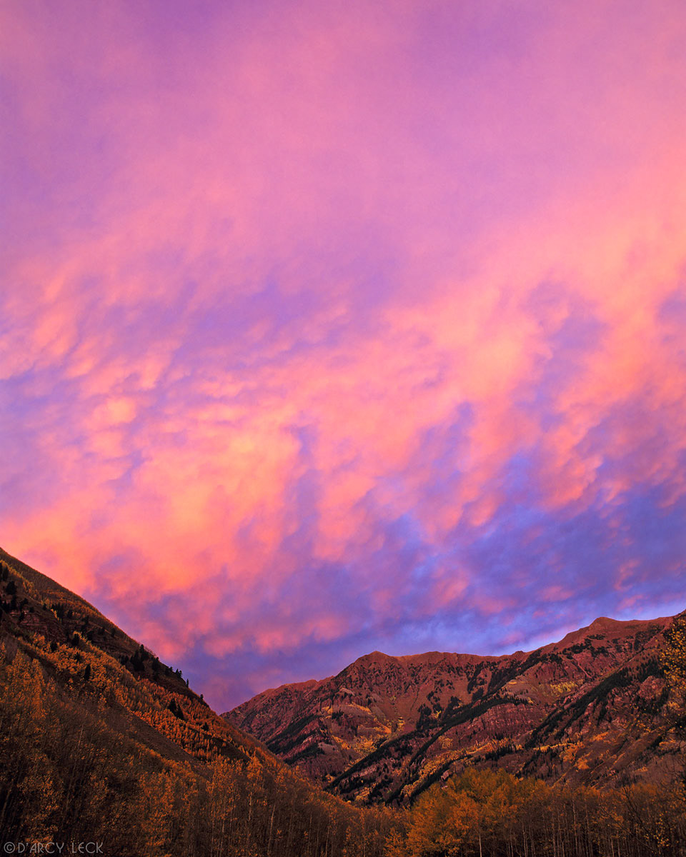 Clouds at sunset over mountains and aspen trees in autumn, Maroon Bells - Snowmass Wilderness, Colorado