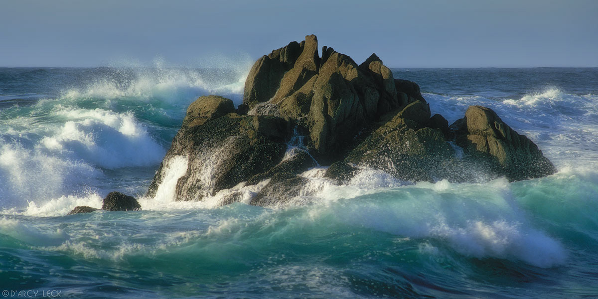 Waves crash against rocks along Pacific Ocean coast at Asilomar State Beach, Monterey Peninsula, California
