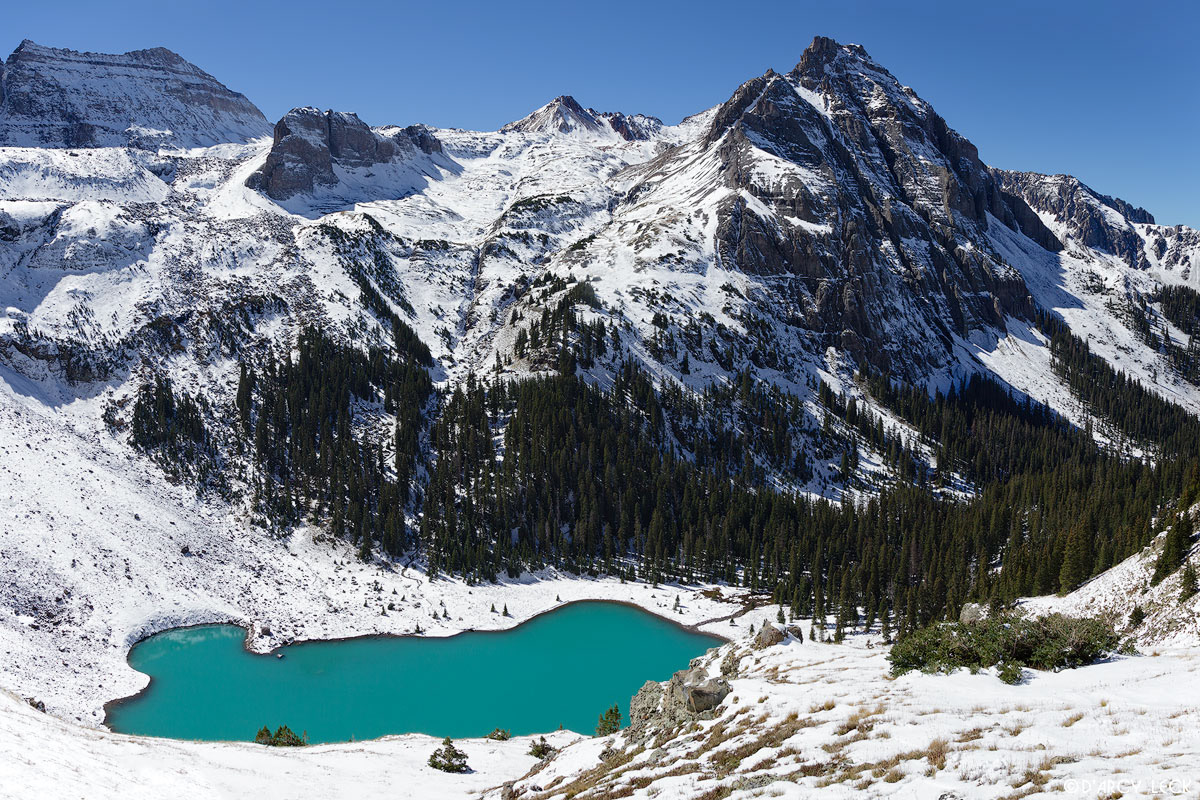 The lowest lake of the Blue Lakes lies below Walcott Mountain after early Autumn snow in the San Juan Mountains, Colorado