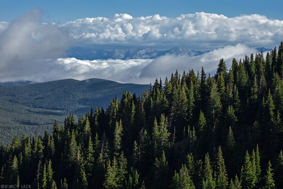 Morning clouds clear from forest and mountains near Cumberland Pass, Colorado