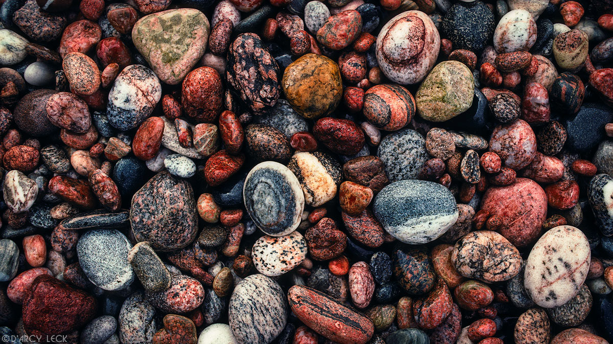 Wet wave-polished rocks on beach near Agawa Bay, Lake Superior, Ontario, Canada