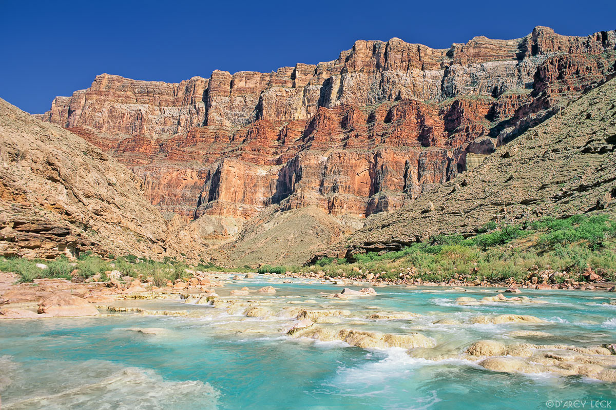 Aquamarine waters of the Little Colorado River flow towards its confluence with the Colorado River in Marble Canyon, Arizona