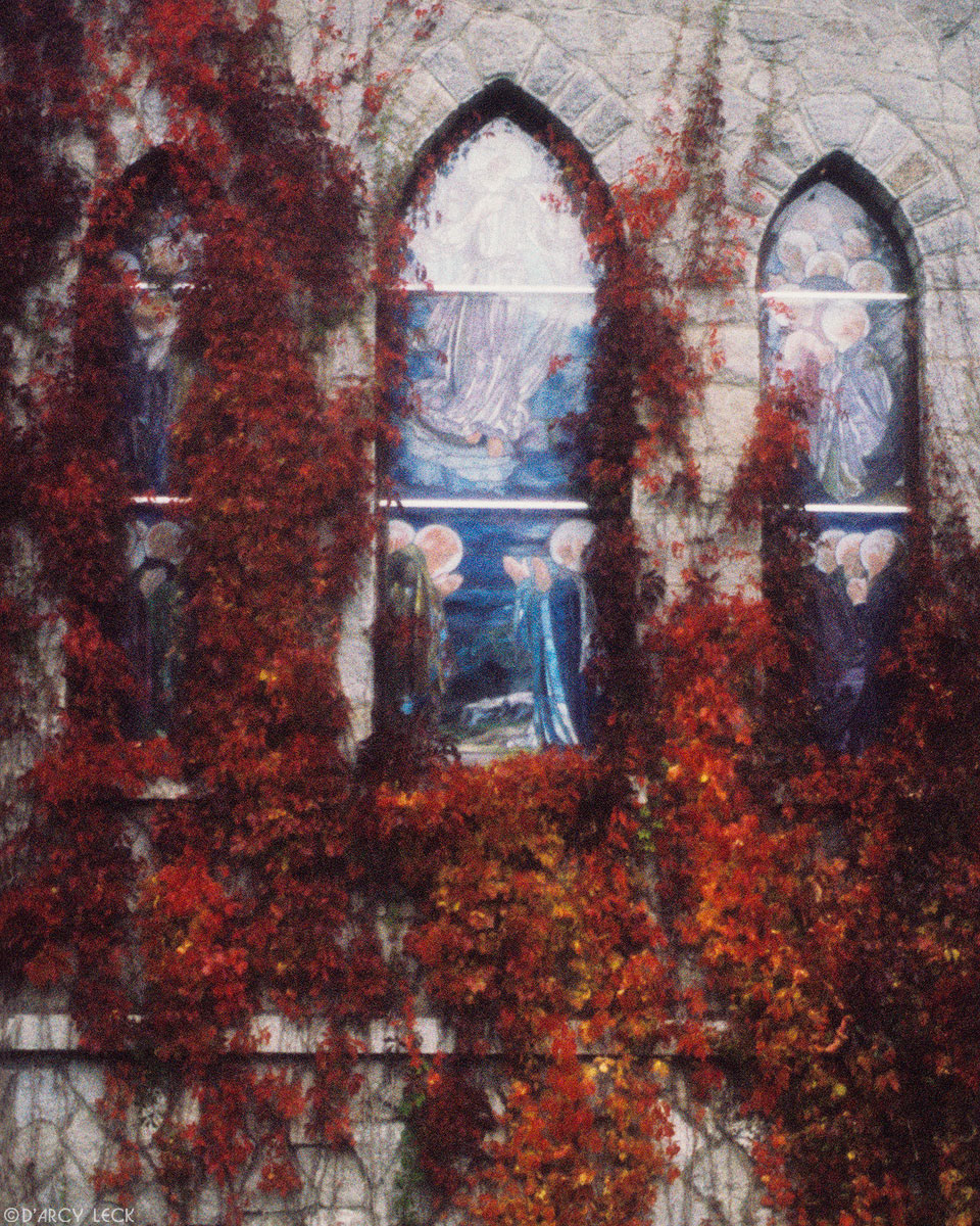 Stained glass windows and ivy in autumn surround church window, New Hampshire