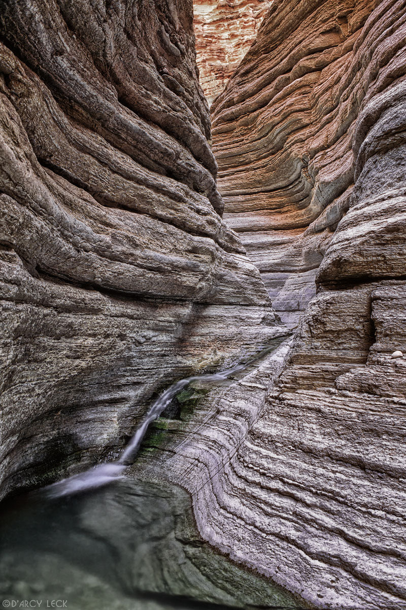 Water falls down slot canyon, Matkatamiba Canyon, Grand Canyon National Park