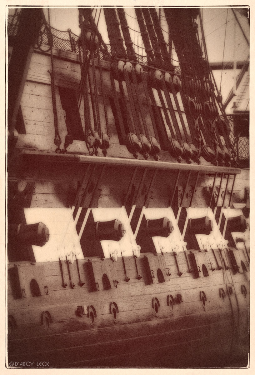 Guns protrude from gun ports and rigging along starboard side of the USS Constitution