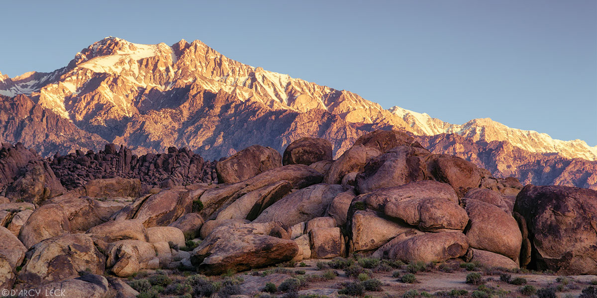 Sunrise light on Mount Williamson and Sierra Nevada Mountains with rock formations of Alabama Hills, California