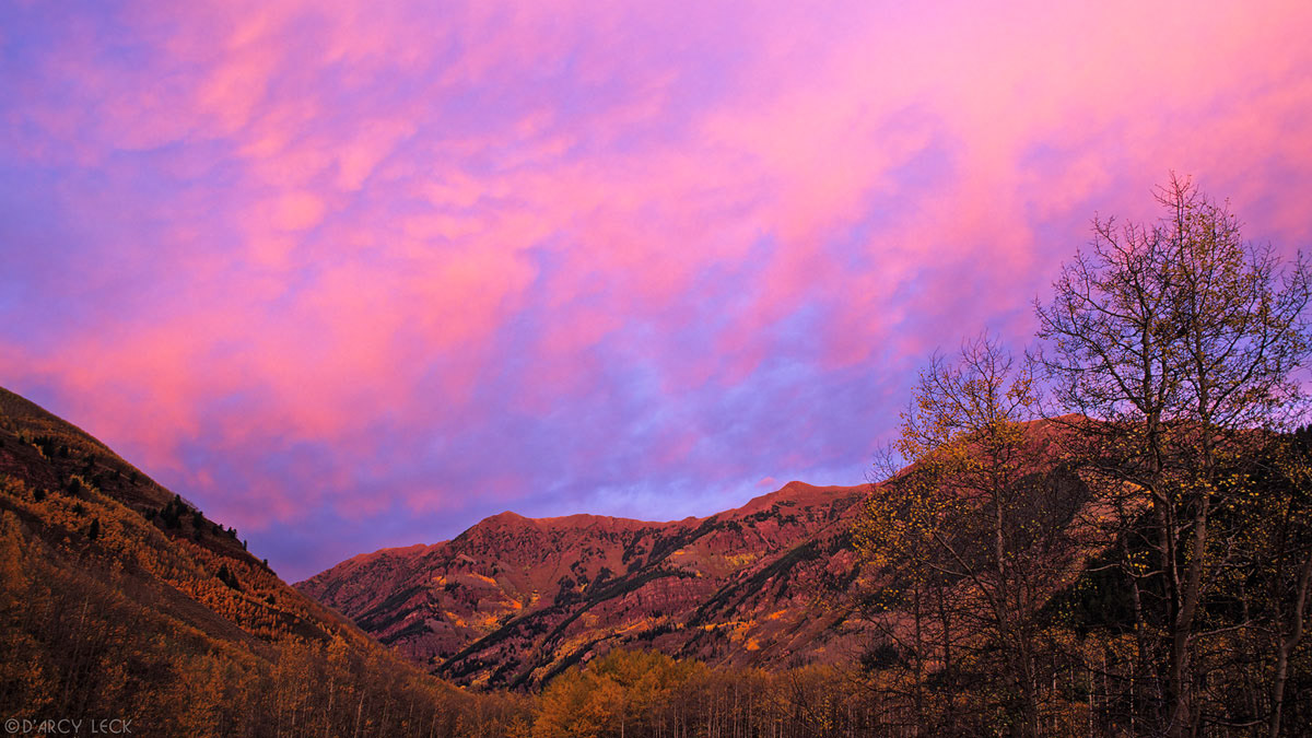 Clouds at sunset over mountains and aspen trees in autumn, Maroon Bells - Snowmass Wilderness, Colorado