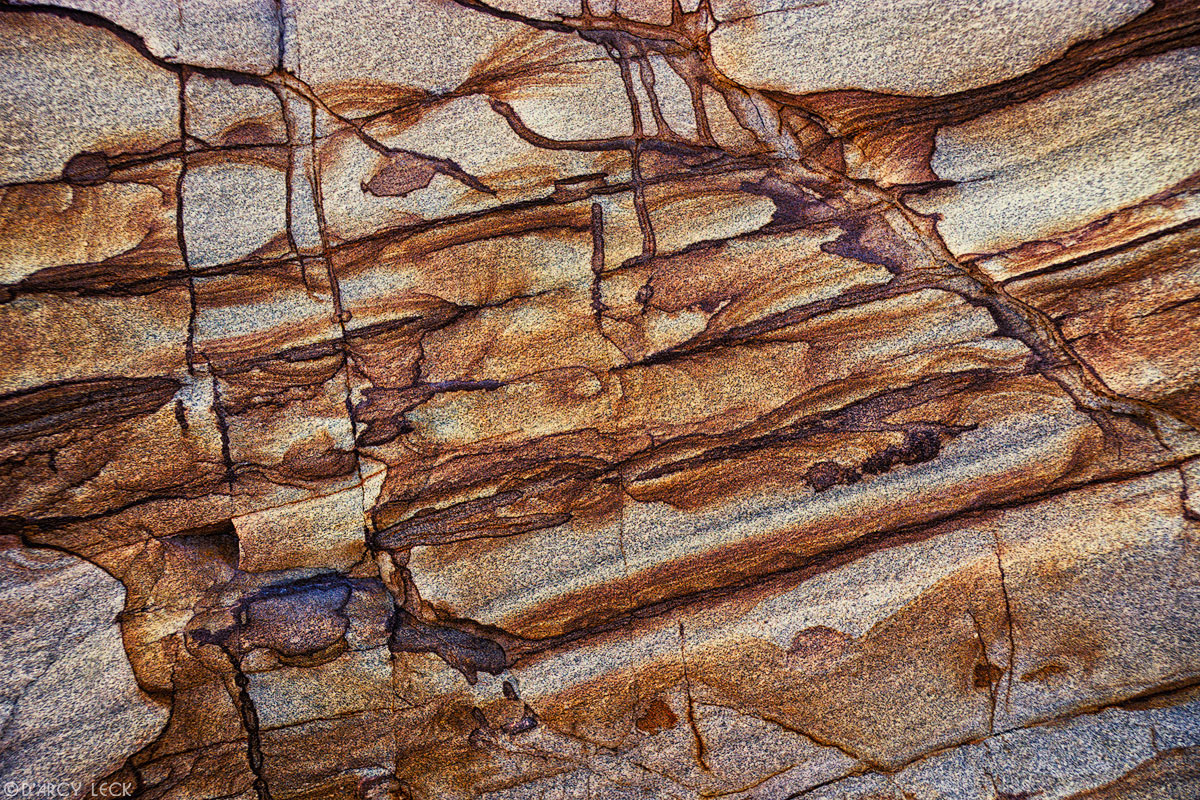 Striations and cracks in tan and gray sandstone, Point Reyes National Seashore, California