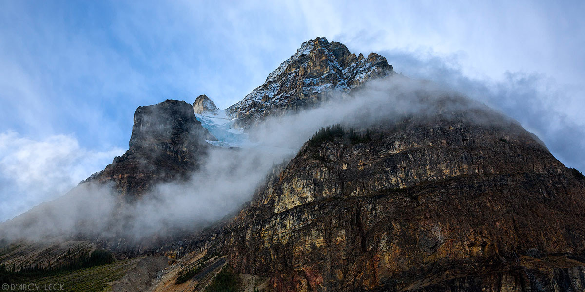 Clouds linger around the slopes of Mount Field after storm in Yoho National Park, British Columbia, Canada