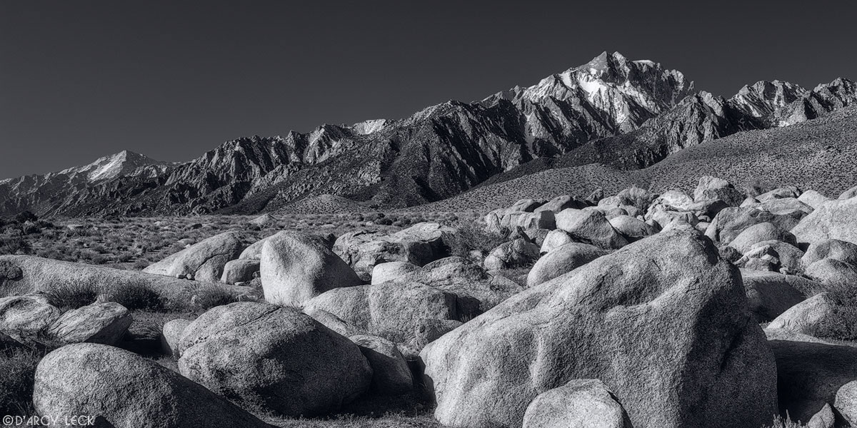 Rocks scattered across the landscape in the Alabama Hills with the Sierra Nevada Mountains beyond, California