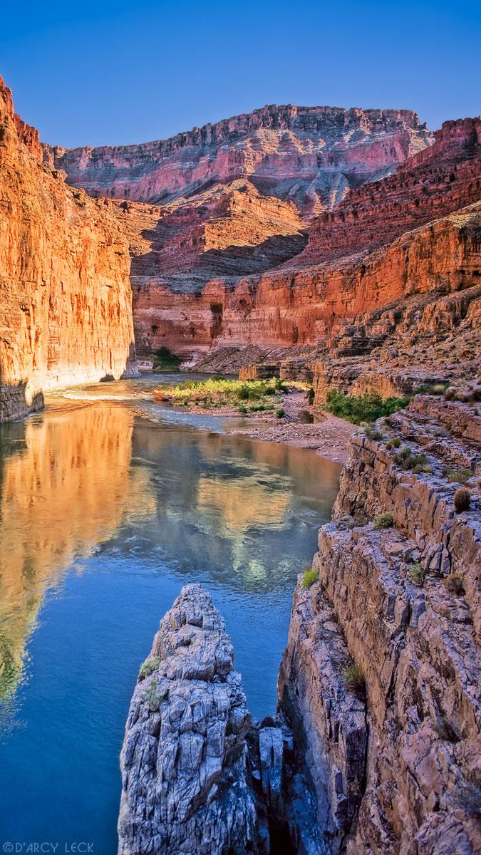 Colorado River flows past canyon walls of Marble Canyon near the outflow of South Canyon, Arizona