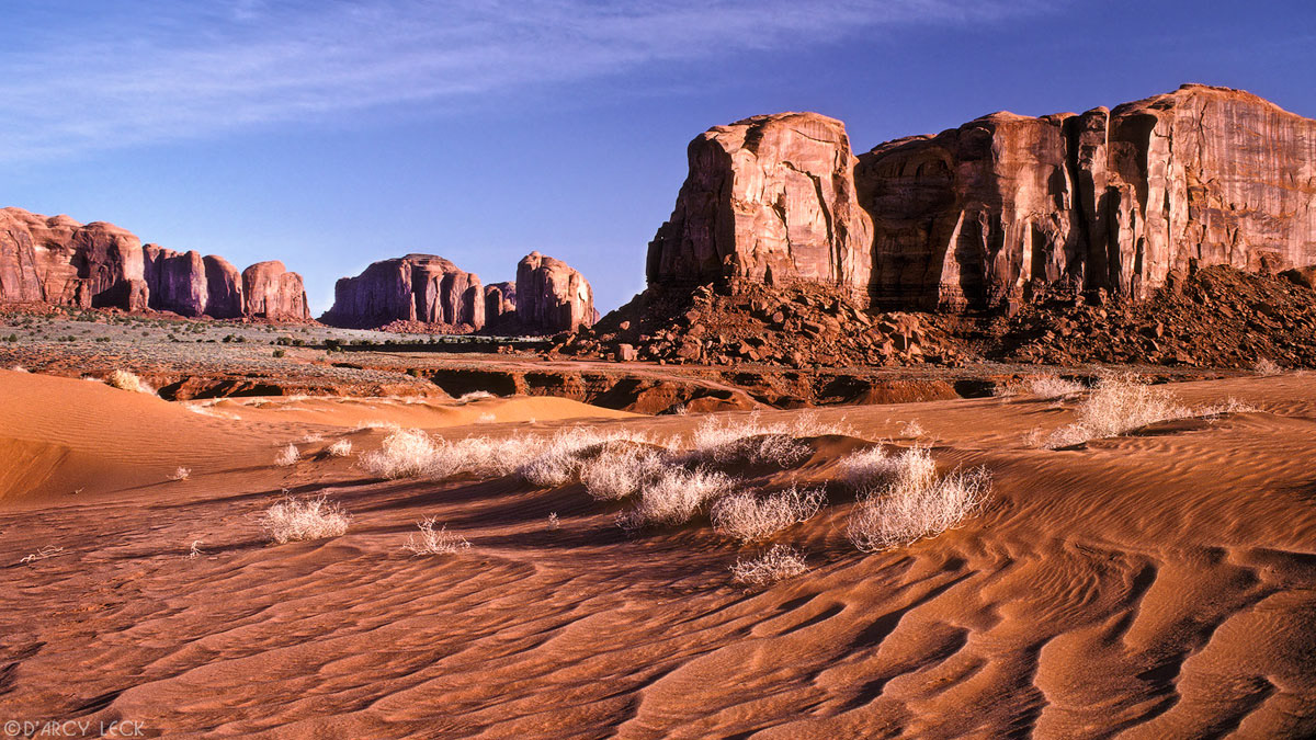Small sand dunes ripple with Spearhead Mesa beyond, Monument Valley, Arizona