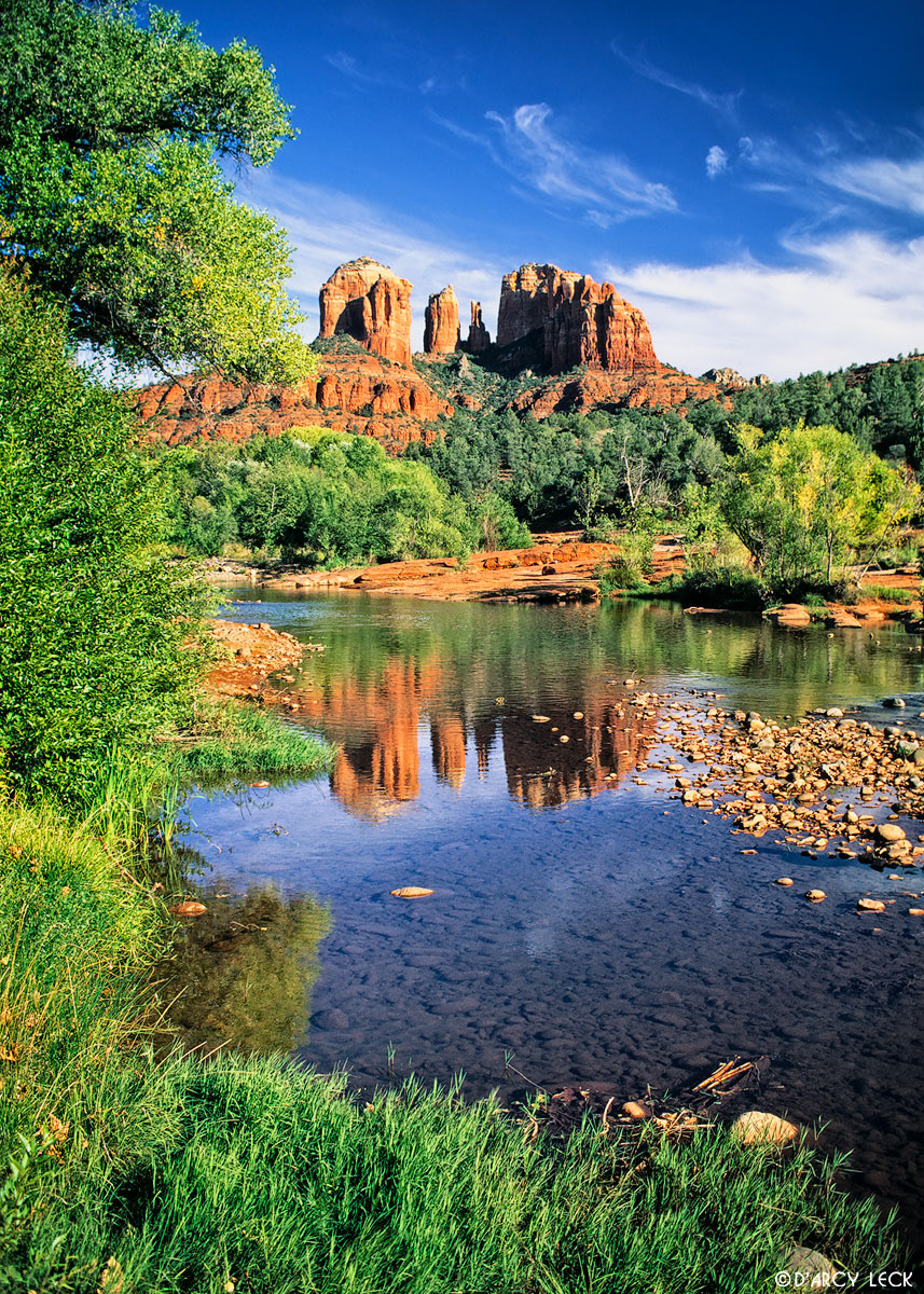 Oak Creek flows through red rocks with the Cathedral Rocks in the distance, Arizona