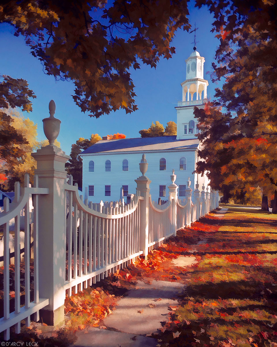 Autumn foliage frames the white fence and First Colonial Church of Bennington, Vermont