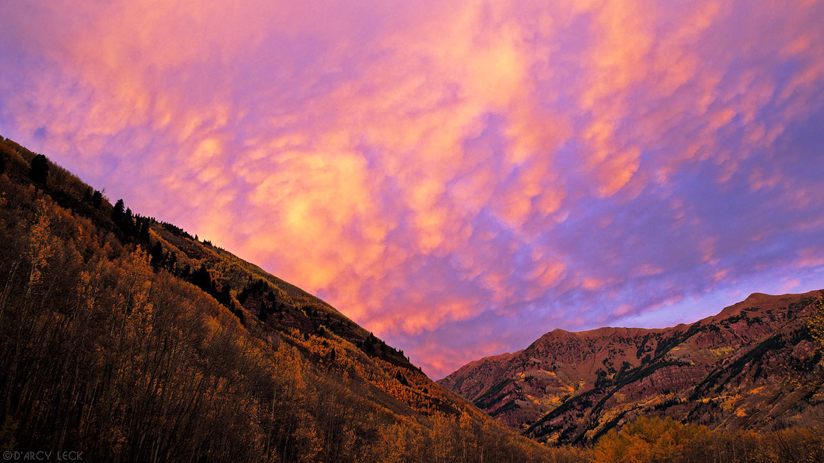 Clouds at sunset over mountains and aspen trees in autumn, Maroon Bells - Snowmass Wilderness, Colorado