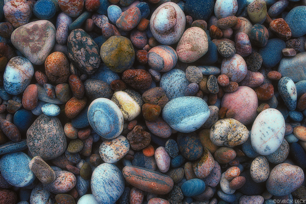 Wave polished stones on shore of Agawa Bay on Lake Superior, Ontario, Canada