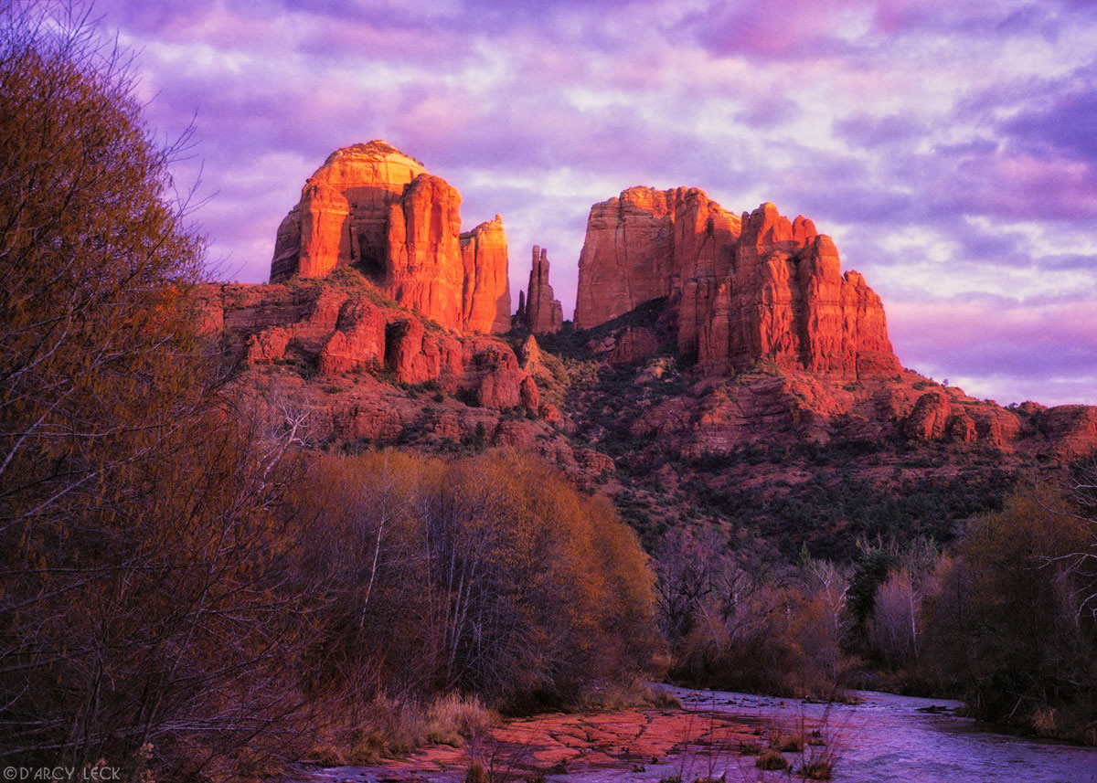 Cathedral Rocks catch the last sunlight at sunset beyond Oak Creek in winter, Arizona