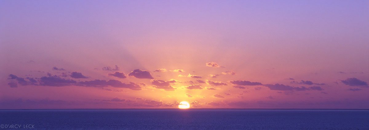 Sun rising from horizon of Caribbean Sea near the Abacos, Bahamas