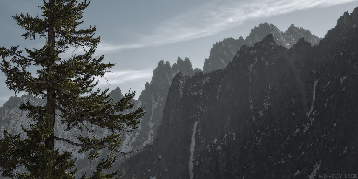 Morning sunlight glows behind the Snagtooth Ridge in the Cascade Range mountains, Washington
