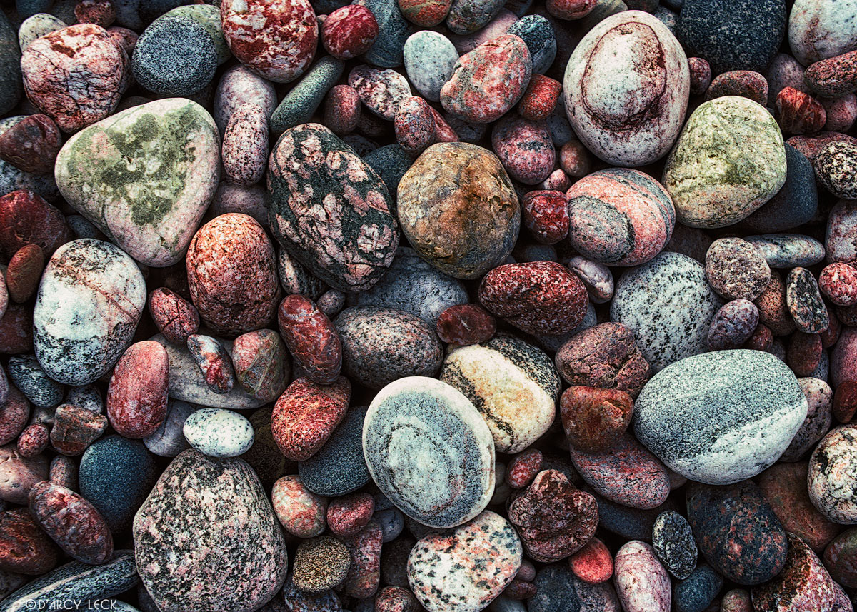Wave polished stones on shore of Agawa Bay on Lake Superior, Ontario, Canada
