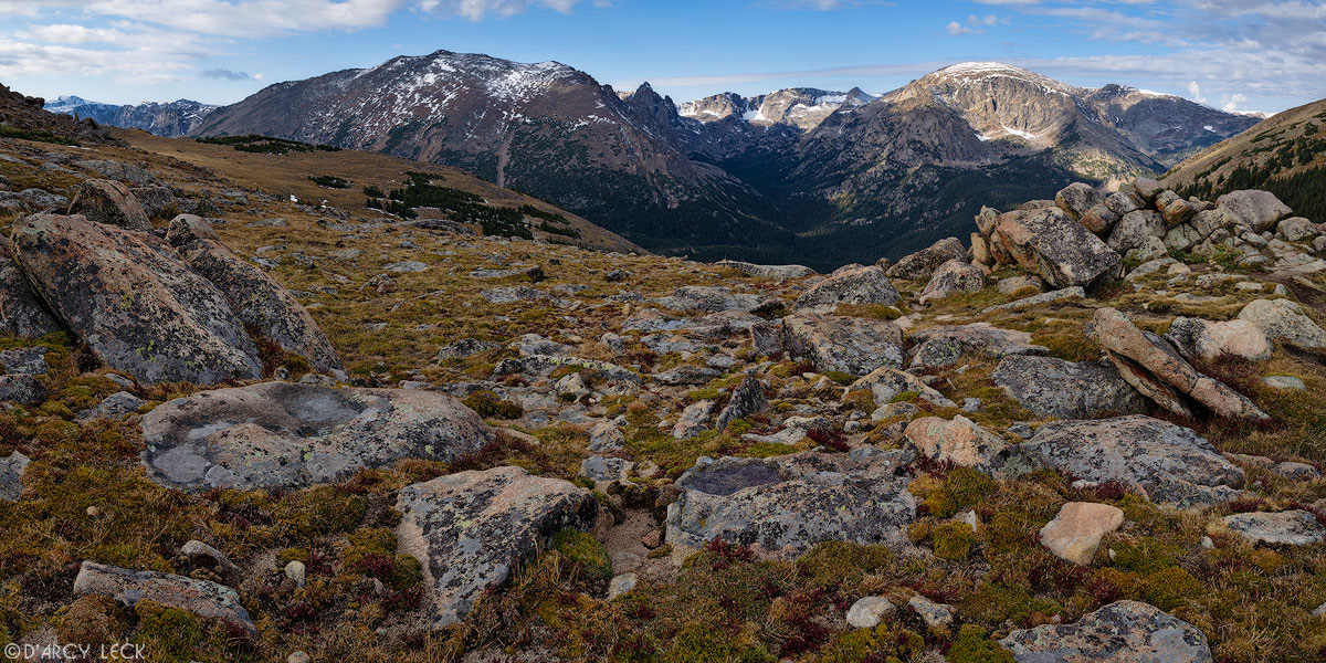 Rocky alpine terrain above Forest Canyon with Rocky Mountains along the Continental Divide in the distance, Colorado