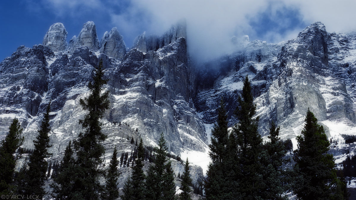 Winter clouds clearing from rugged peak in Rocky Mountains, Jasper National Park, Canada