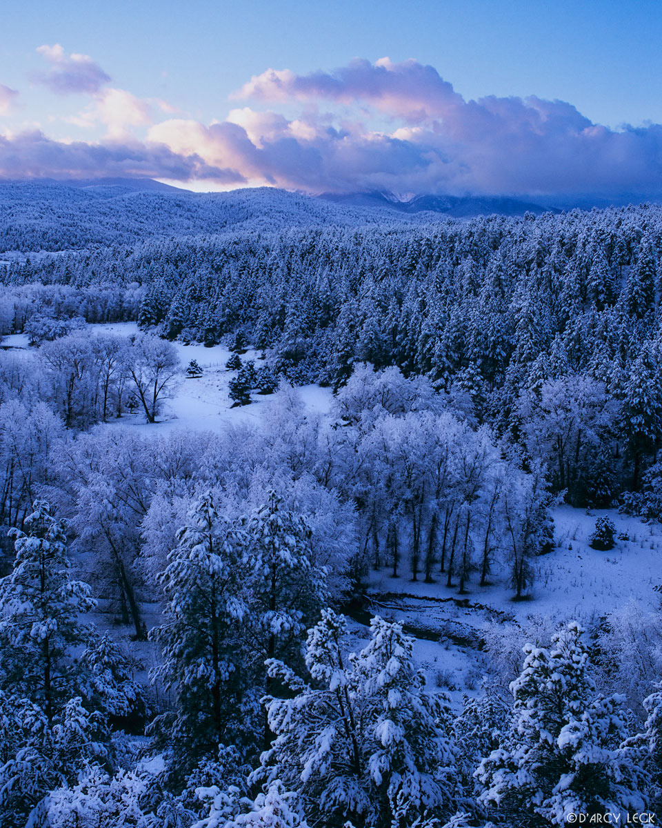 Clearing clouds over Sangre de Cristo Mountains at sunrise and fresh snow in Carson National Forest, New Mexico, USA