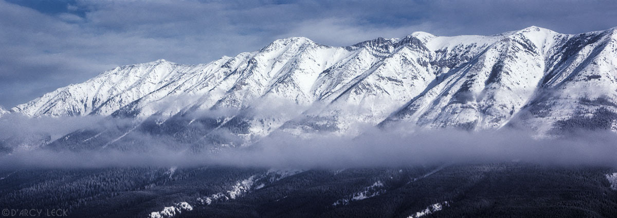 Snow covered Rocky Mountains rise above the Columbia River valley in British Columbia, Canada