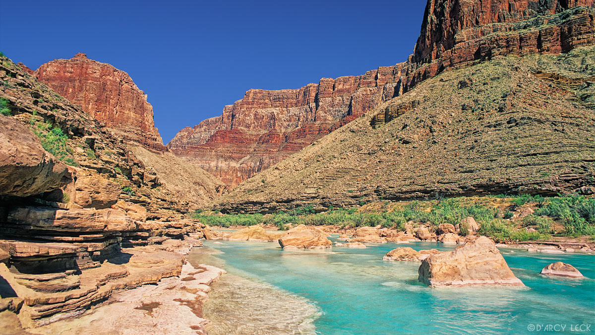 Aquamarine waters of the Little Colorado River flow towards its confluence with the Colorado River in Marble Canyon, Arizona