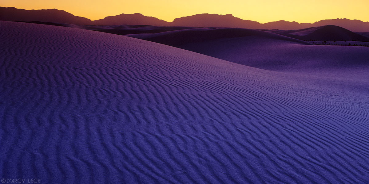 Warm glow of sunset sky over sand dunes at White Sands National Monument, New Mexico, USA