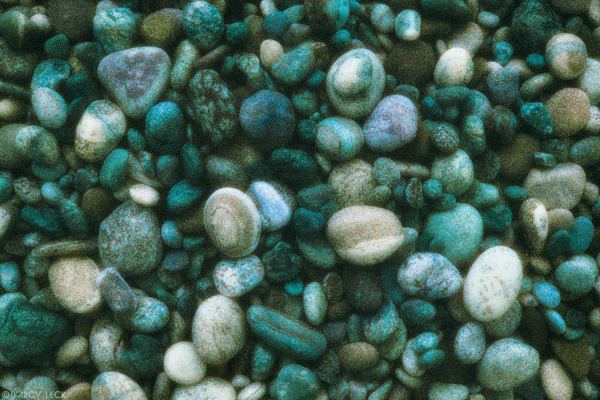Wet wave-polished rocks on beach near Agawa Bay, Lake Superior, Ontario, Canada