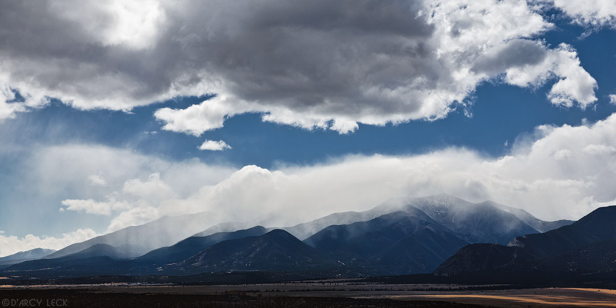 Autumn storm clouds enshroud Mount Antero, Mount White, and Mount Shavano in the Swatch Range Mountains beyond the Arkansas River Valley near Salida, Colorado