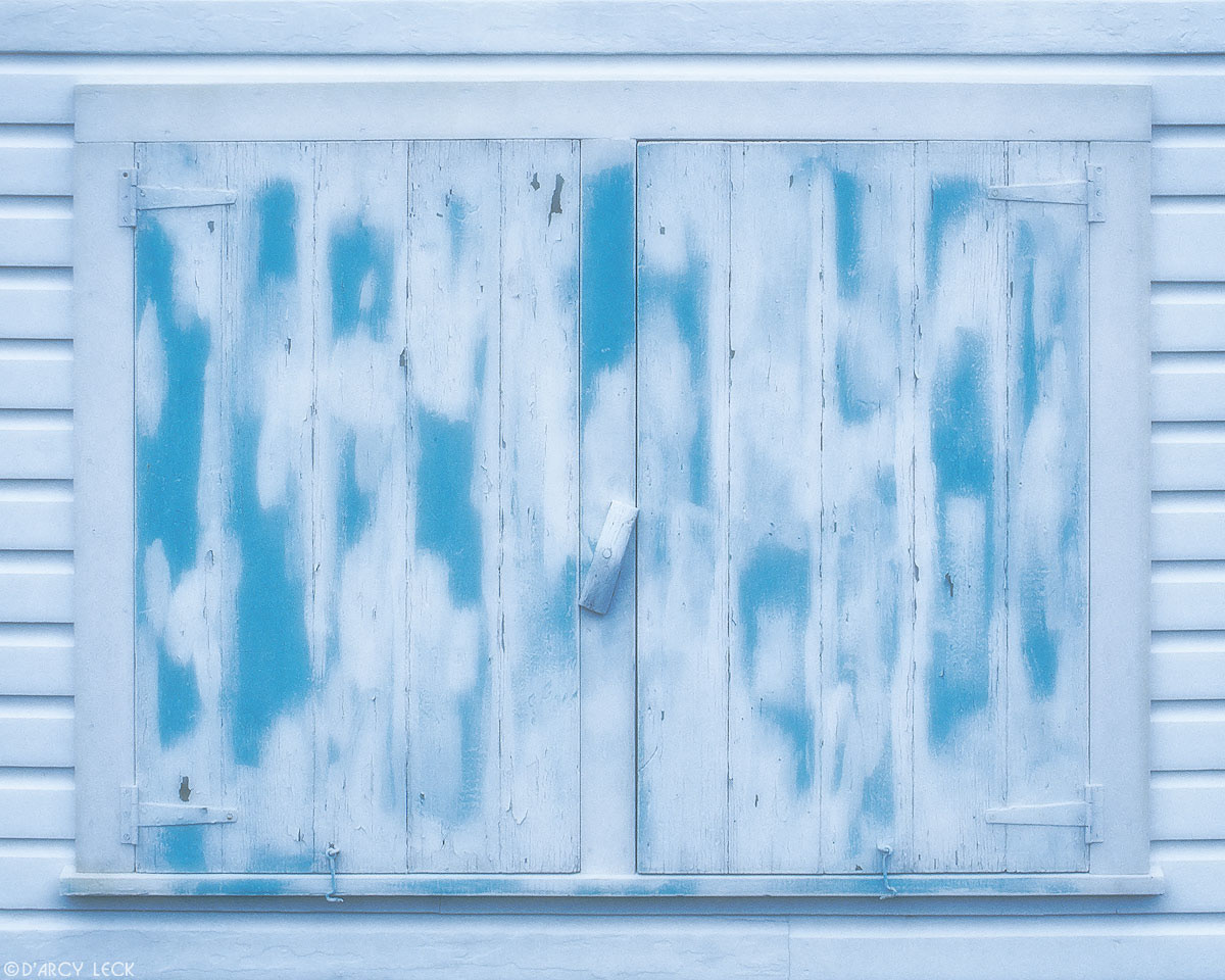Blue paint on shuttered window on Man-O-War Cay Bahamas