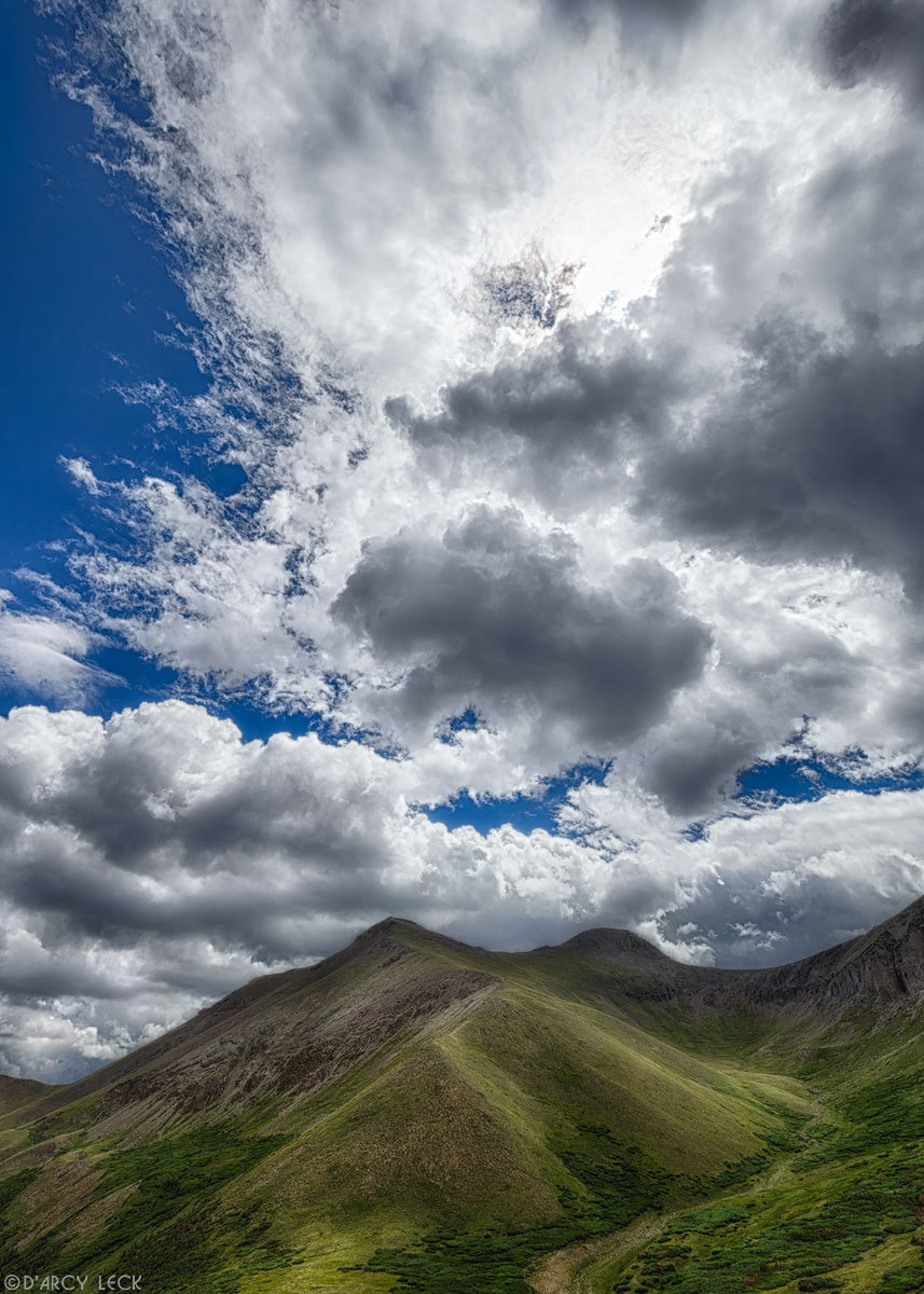 Summer cumulus clouds form over Organ Mountain in the San Juan Mountain range, Colorado