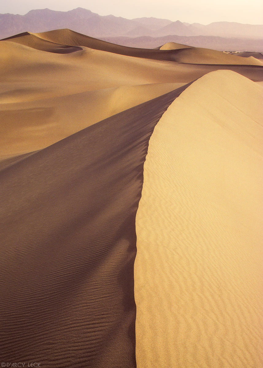 Sand dunes with Panamint mountains in distance, California