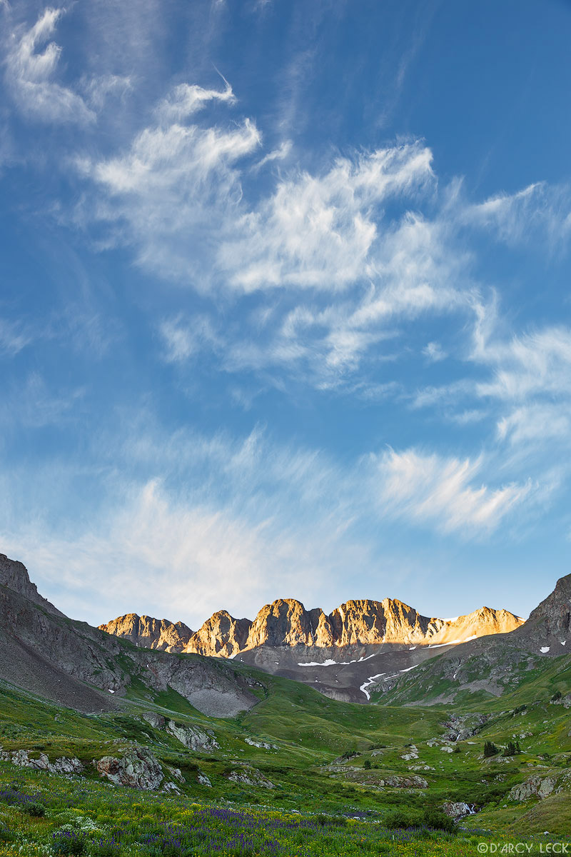 Sunrise illuminates the mountain tops above American Basin in July, Colorado