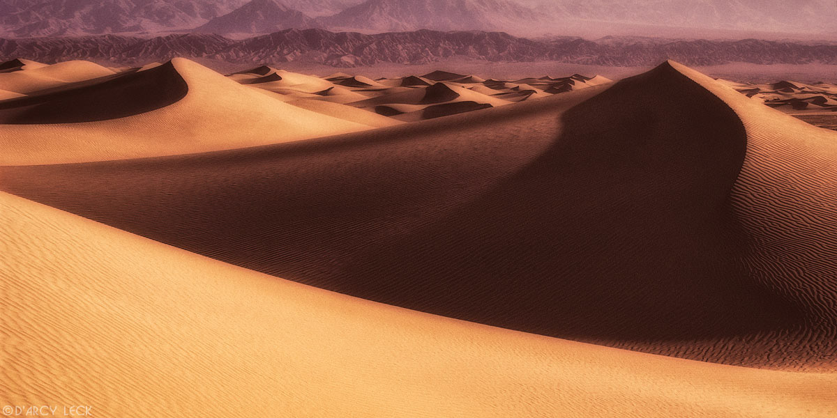 Sand dunes with Panamint mountains in distance, California