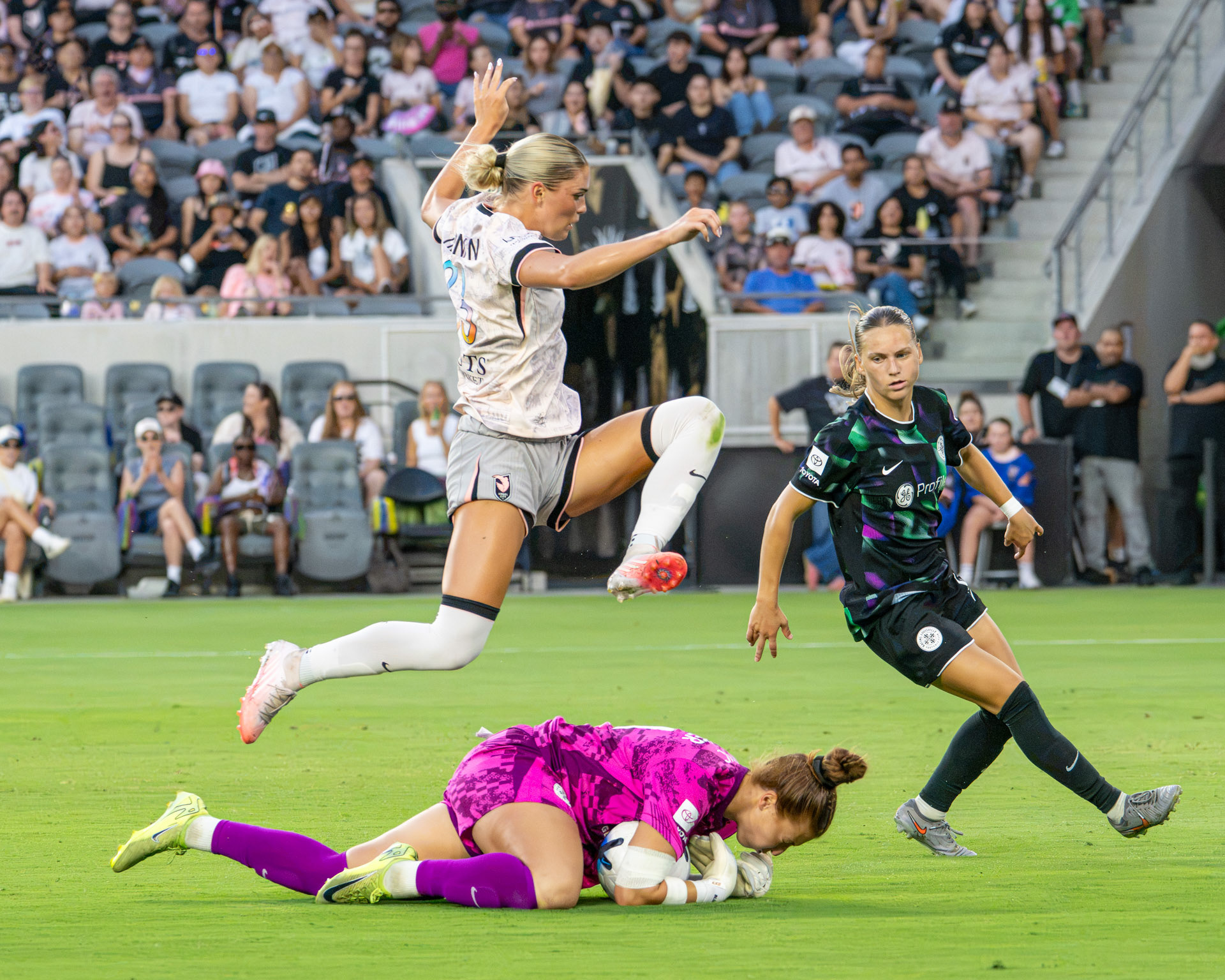 Angel City FC (#33/W) Riley Tiernan leaps over the opposing goalkeeper on July 26th 2026. 