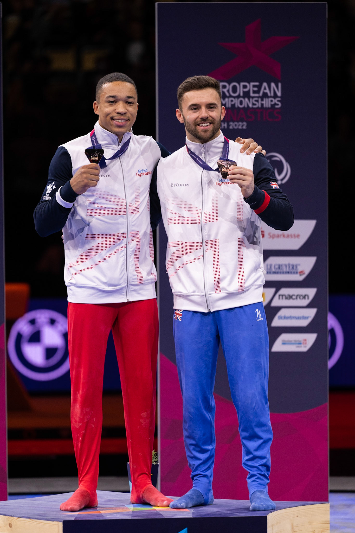 European Championships 2022, Apparatus Final, Parallel BarsDepicted: Joe Fraser, Giarnni Regini-MoranPhoto taken in Munich, DEU on 2022-08-21Photo credits should read: Norman Seibert, CC BY-SA 4.0NIKON Z 9, NIKKOR Z 70-200mm f/2.8 VR S¹⁄₈₀₀ Sek. bei ƒ / 4,0File: DSC_7117.NEF