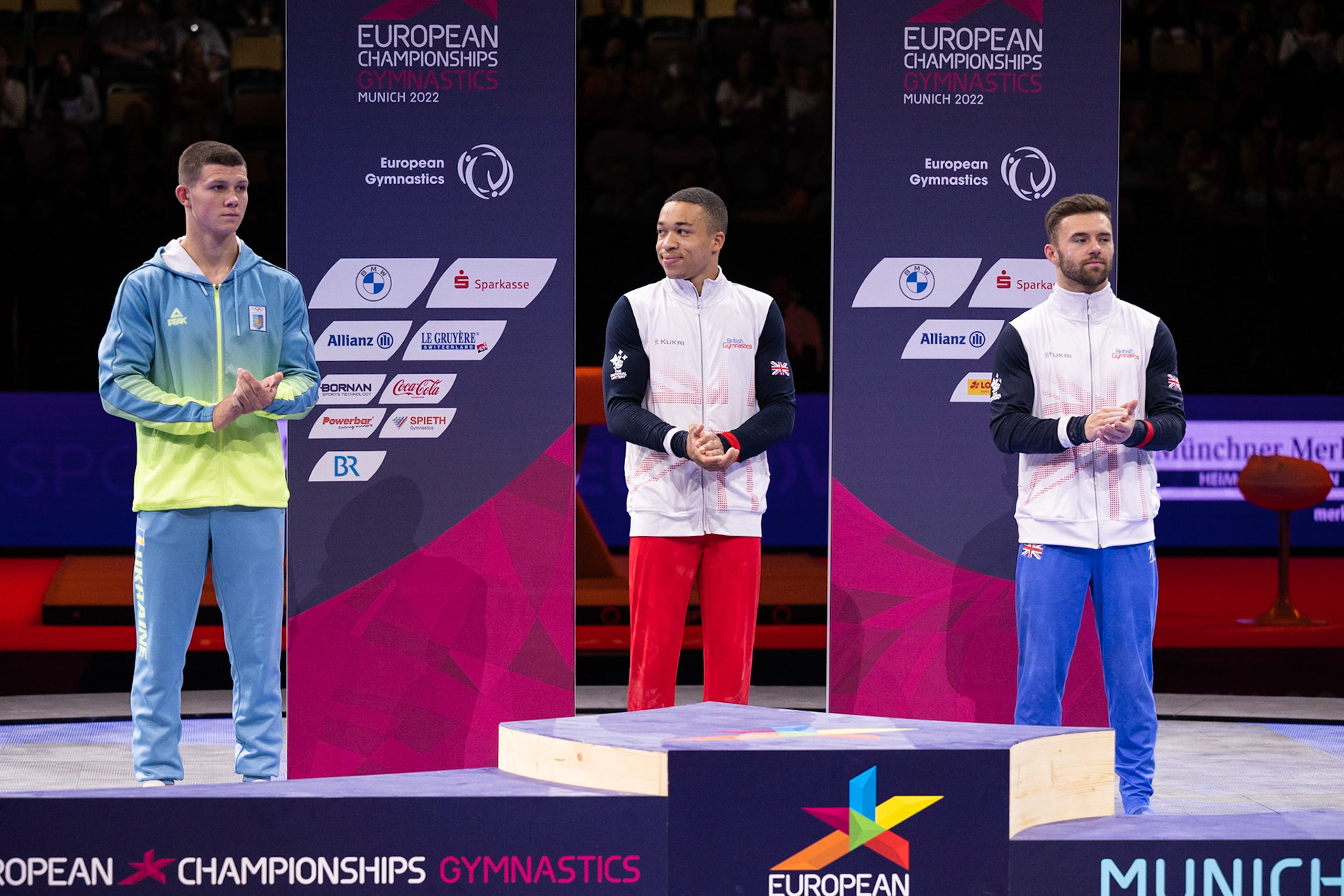 European Championships 2022, Apparatus Final, Parallel BarsDepicted: Giarnni Regini-Moran, Joe Fraser, Illia KovtunPhoto taken in Munich, DEU on 2022-08-21Photo credits should read: Norman Seibert, CC BY-SA 4.0NIKON Z 9, NIKKOR Z 70-200mm f/2.8 VR S¹⁄₈₀₀ Sek. bei ƒ / 4,0File: DSC_6907.NEF