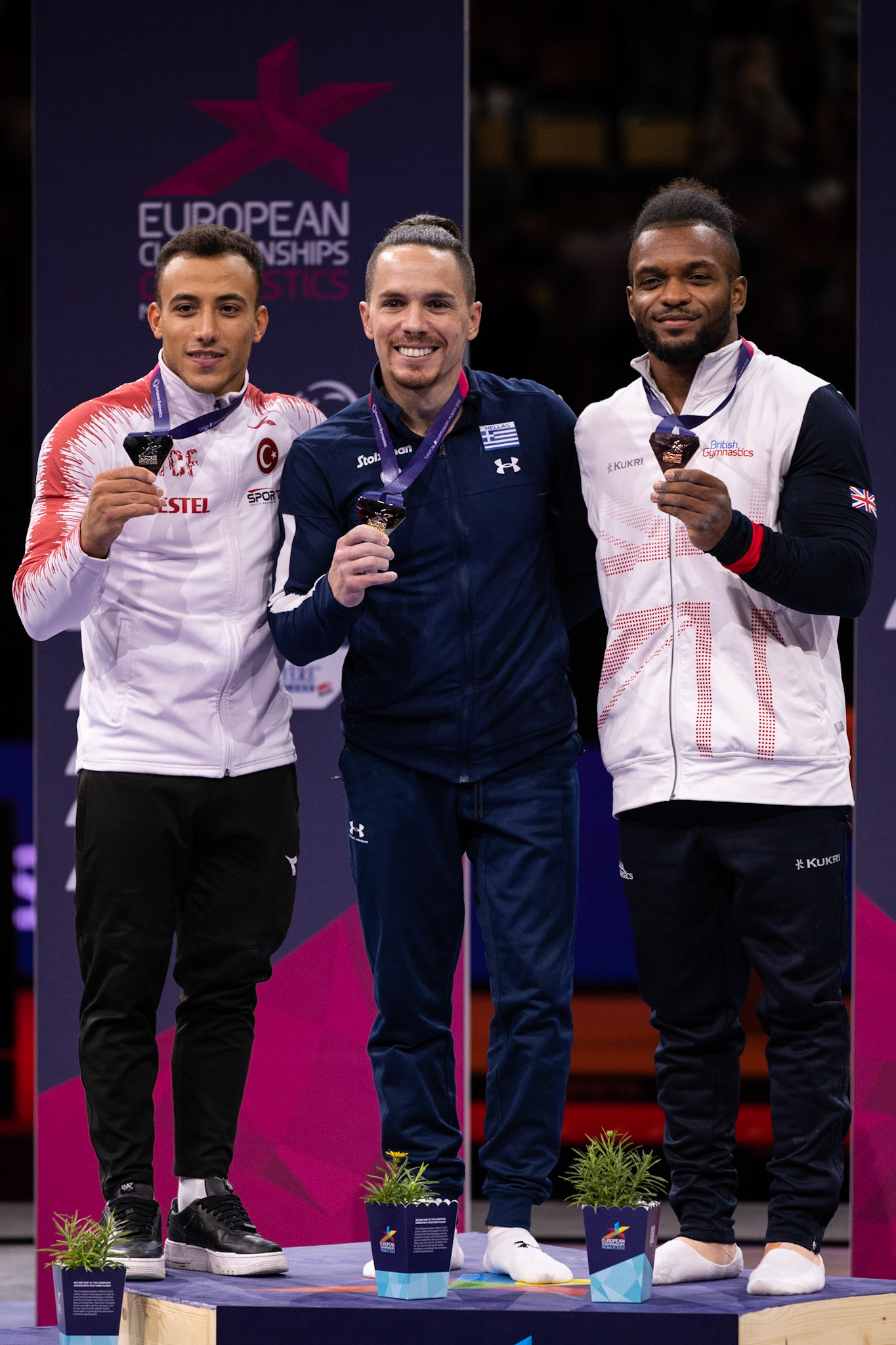 European Championships 2022, Apparatus Final, Victory CeremonyDepicted: Adem Asil, Eleftherios Petrounias, Courtney TullochPhoto taken in Munich, DEU on 2022-08-21Photo credits should read: Norman Seibert, CC BY-SA 4.0NIKON Z 9, NIKKOR Z 70-200mm f/2.8 VR S¹⁄₈₀₀ Sek. bei ƒ / 4,0File: DSC_3712.NEF