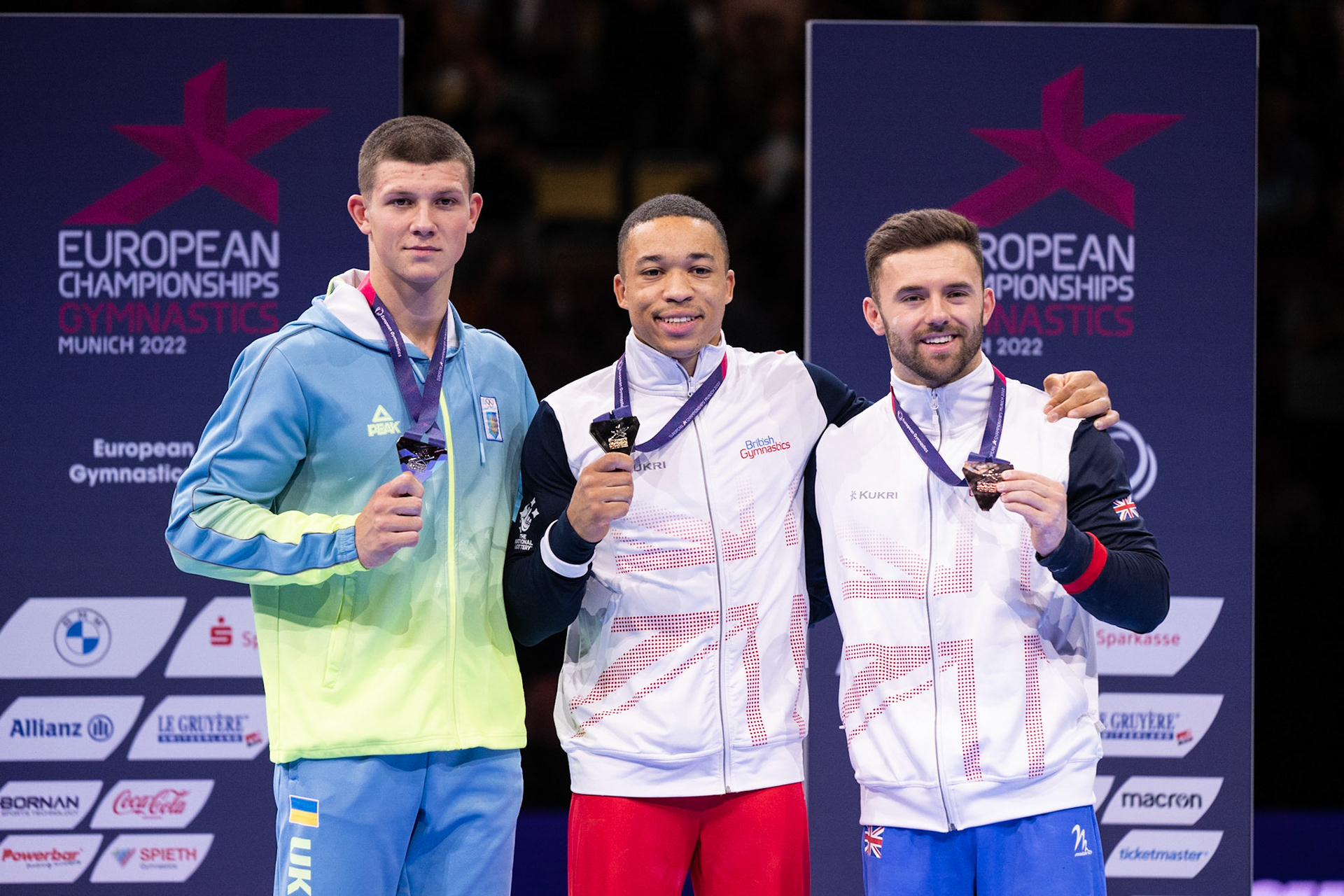 European Championships 2022, Apparatus Final, Parallel BarsDepicted: Illia Kovtun, Giarnni Regini-Moran, Joe FraserPhoto taken in Munich, DEU on 2022-08-21Photo credits should read: Norman Seibert, CC BY-SA 4.0NIKON Z 9, NIKKOR Z 70-200mm f/2.8 VR S¹⁄₈₀₀ Sek. bei ƒ / 4,0File: DSC_7096.NEF