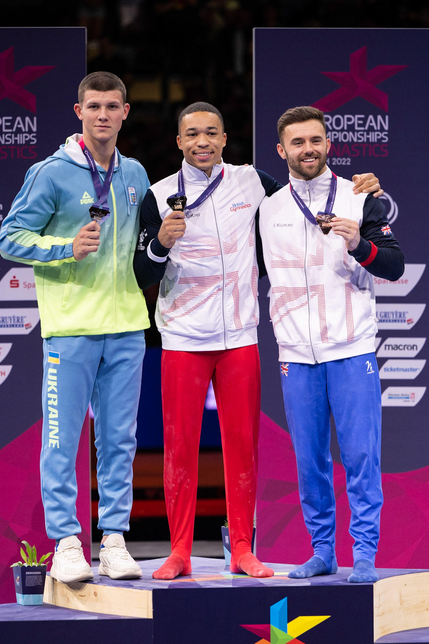 European Championships 2022, Apparatus Final, Parallel BarsDepicted: Illia Kovtun, Giarnni Regini-Moran, Joe FraserPhoto taken in Munich, DEU on 2022-08-21Photo credits should read: Norman Seibert, CC BY-SA 4.0NIKON Z 9, NIKKOR Z 70-200mm f/2.8 VR S¹⁄₈₀₀ Sek. bei ƒ / 4,0File: DSC_7083.NEF
