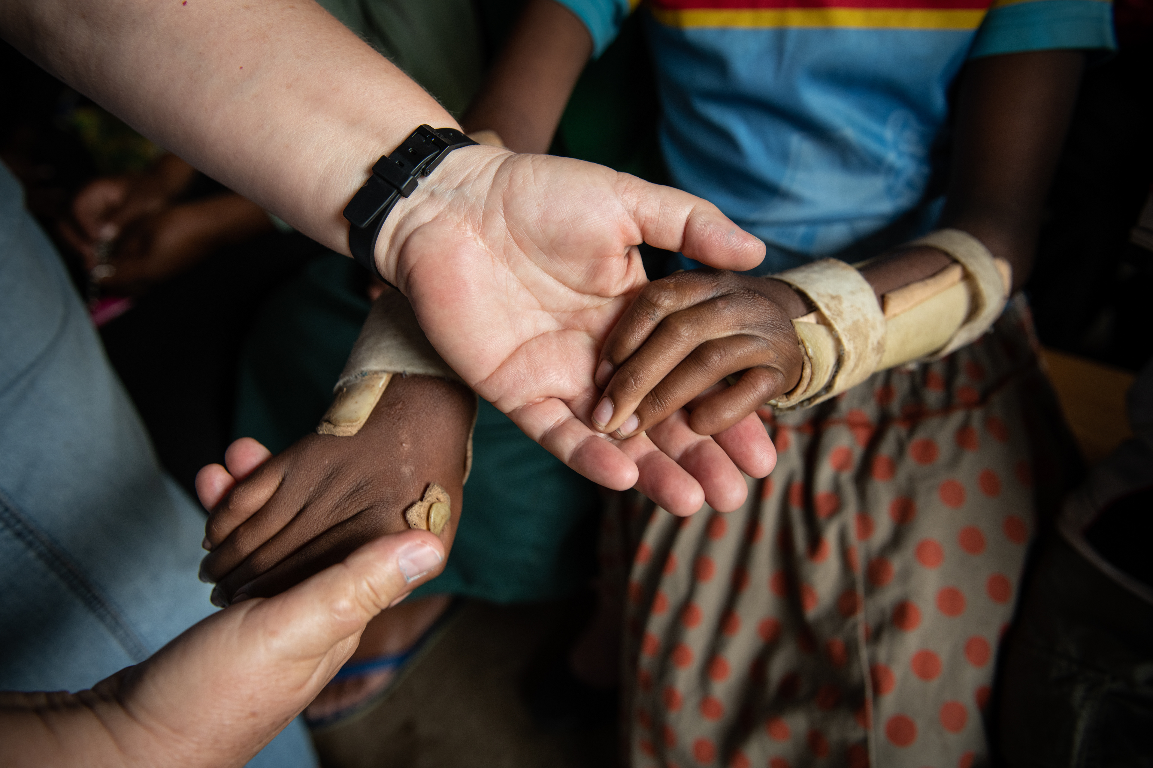 Sister Agnieszka - Sister of the Angels, Polish missionary, holds the hands of one of the beneficiaries of the Maitri Medical Have a Heart Adoption program in Nyakinama, Rwanda, 2019