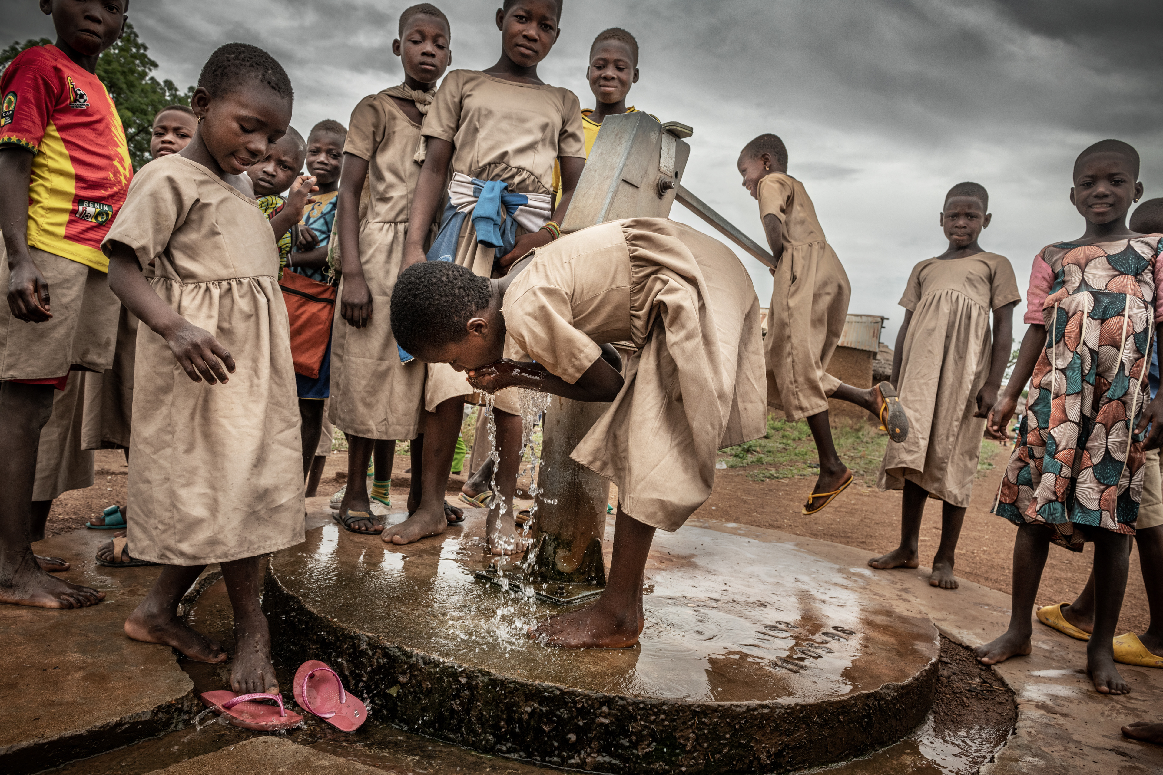 There is no running water at a primary school in Nampoch, Togo. Students must work as a team during breaks to get a drink of water. Togo 2023