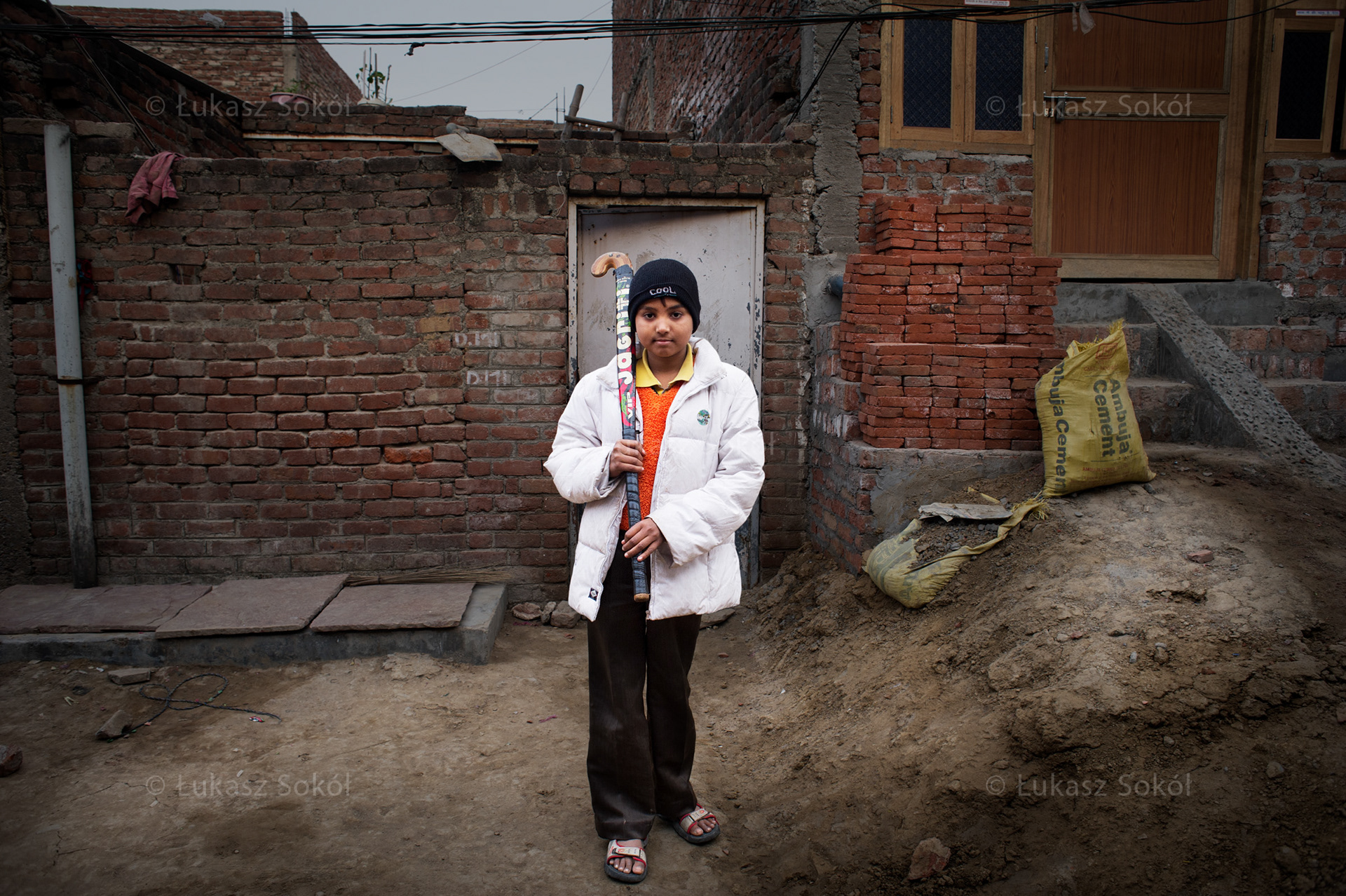 Mohd Sikandar Ansari, 13 years old. He has an older brother. He goes to a sports school where he plays field hockey (a national discipline of India). He received the stick from his coach. After school he plays computer games. He dreams of becoming a goalkeeper of India's national field hockey team. New Delhi, India, 2012