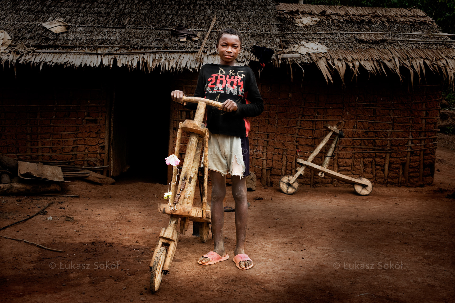 Rosthand Akok, aged 13, he has 2 sisters and a brother. He does not go to school, he cultivates a field. When he saw his brother’s scooter, he made a similar one for himself. He can use it to bring things from the field. Mbege, Cameroon, 2009