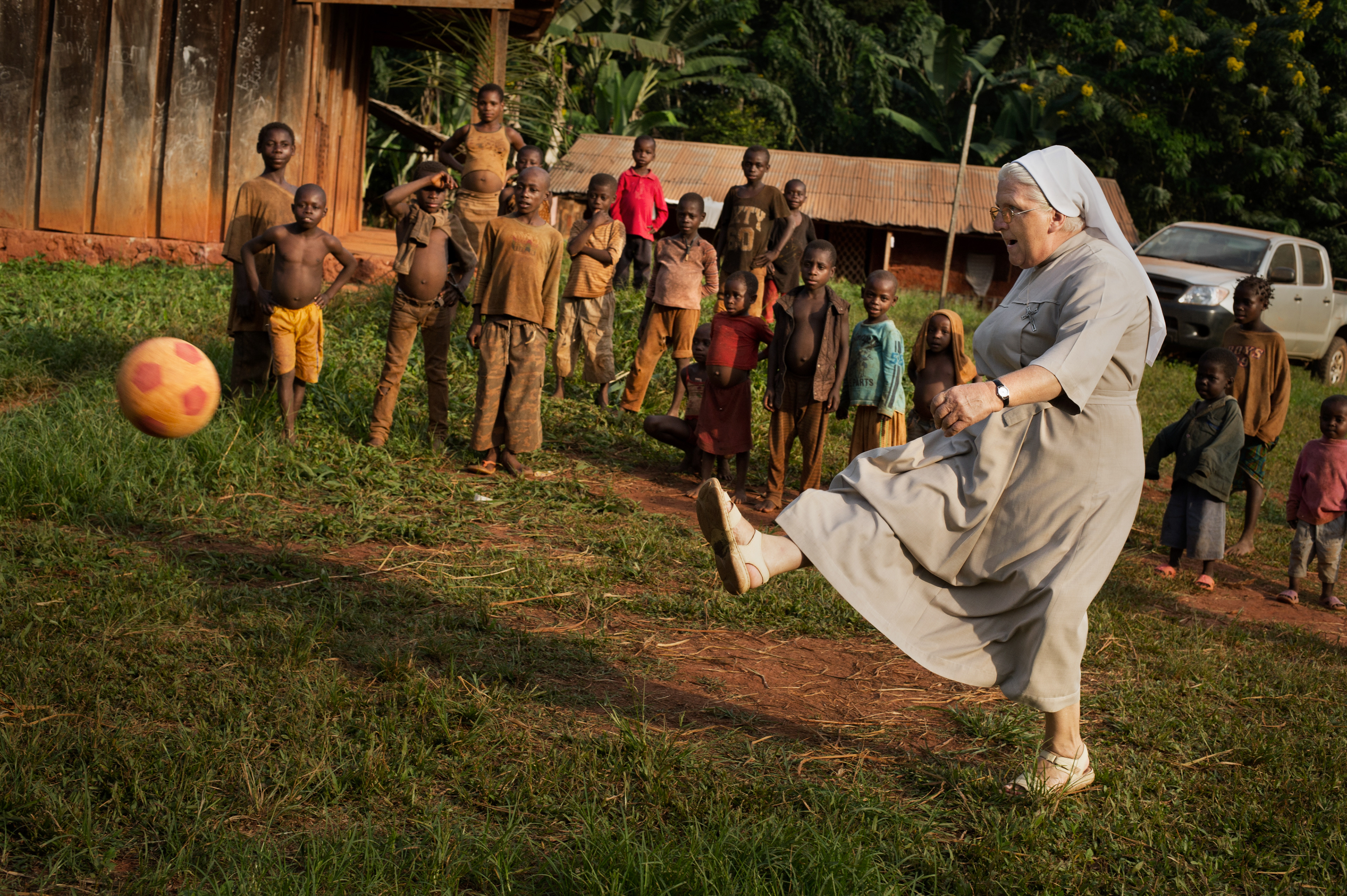 Sister Gabriela of the Congregation of the Sisters of the Soul of Christ the Lord with her pupils in the village of Kolembok in Cameroon. The village is inhabited by the Abatwa tribe (called Pygmies). Cameroon 2012