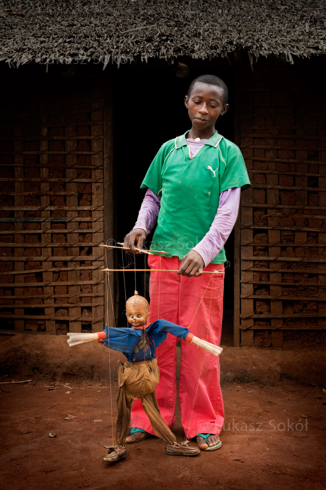 Adjea Biber Boris, aged 12, he has a sister and 5 brothers. In the future he wants to be a mechanic. The marionette was made by himself from his brothers’ things, he saw a similar one in Yaounde, the capital city, which he has visited 3 times. He performs with it in his village during festivals. He dreams of living in a big city one day and having so much money that he wouldn’t know what to do with it. Essiengbot, Cameroon, 2009