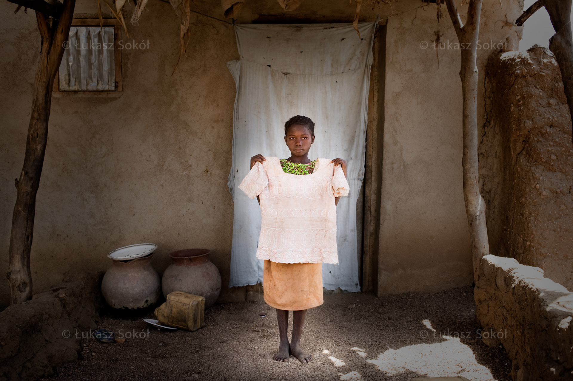 Francoise Todou, aged 11, she has got 2 brothers and 2 sisters. After school she brings water from the well and wood from the bush. She also prepares food. In the future she is going to be a teacher. Her father bought the cloth for the blouse and he sewed it himself. She does not have any other blouses, she wears it only on Sundays when she goes to church. Mandama, Cameroon, 2009
